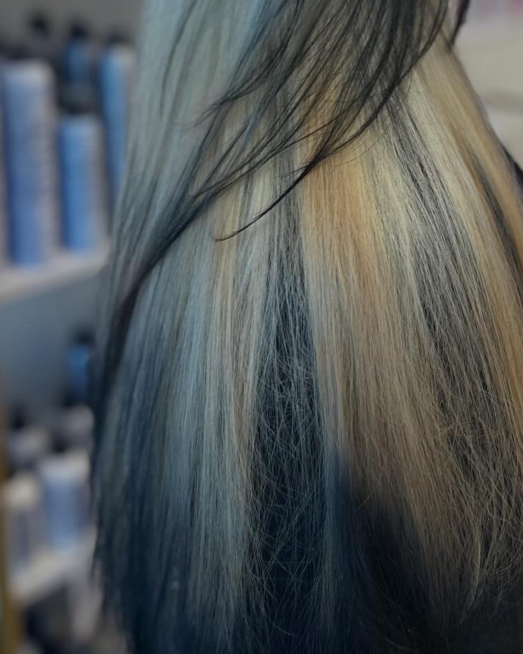 Straight, bright cool blonde with black kept through the underneath, seen from the side after a box-dye color correction by Tori Knox at Canterbury & Co. in Fort Myers.