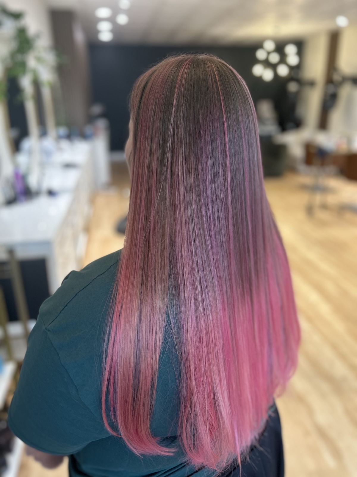 Long straight brunette hair melting into dusty rose pink through the lengths and ends, seen from behind. Vivid color by Tori Knox at Canterbury & Co. Salon in Fort Myers
