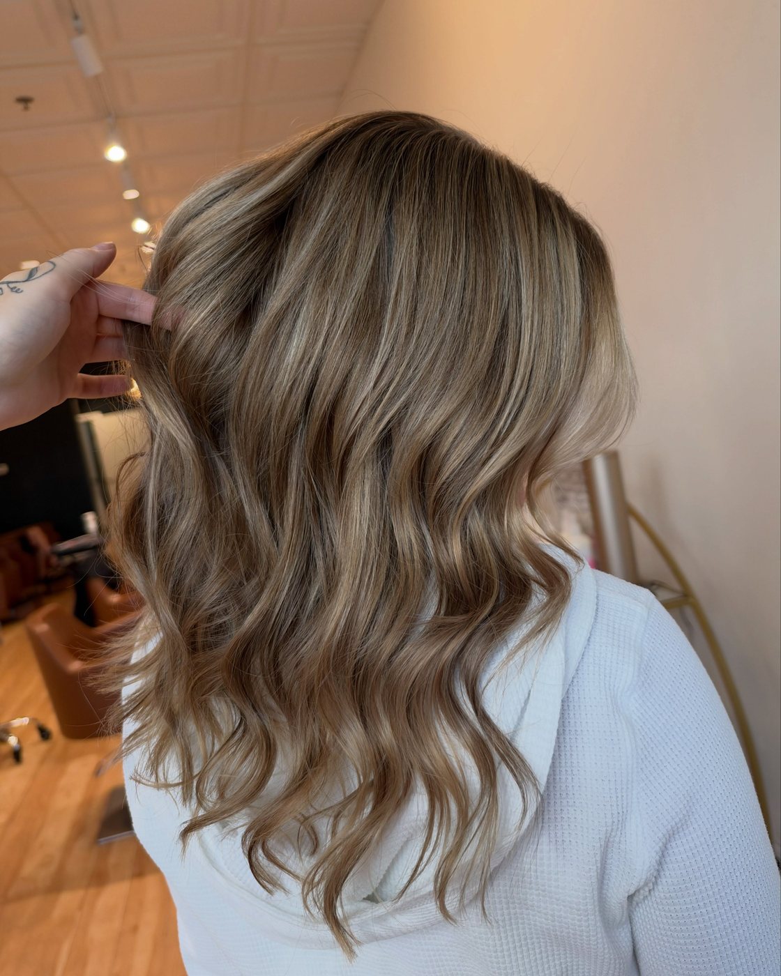 After: the finished dimensional blonde from the side, deeper at the root and brighter through the lengths