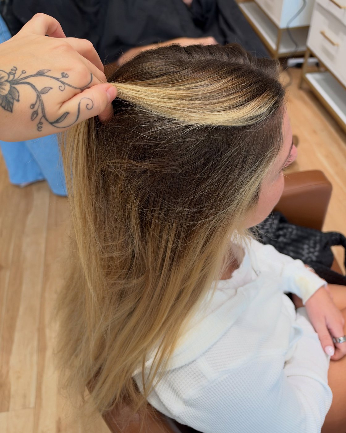 Before: Emma lifting a section to show the regrowth and the old highlight underneath
