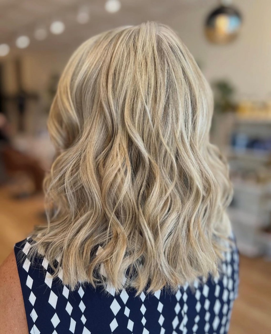 Cool blonde dimensional color in soft waves — work by the Canterbury Color Team in Fort Myers.
