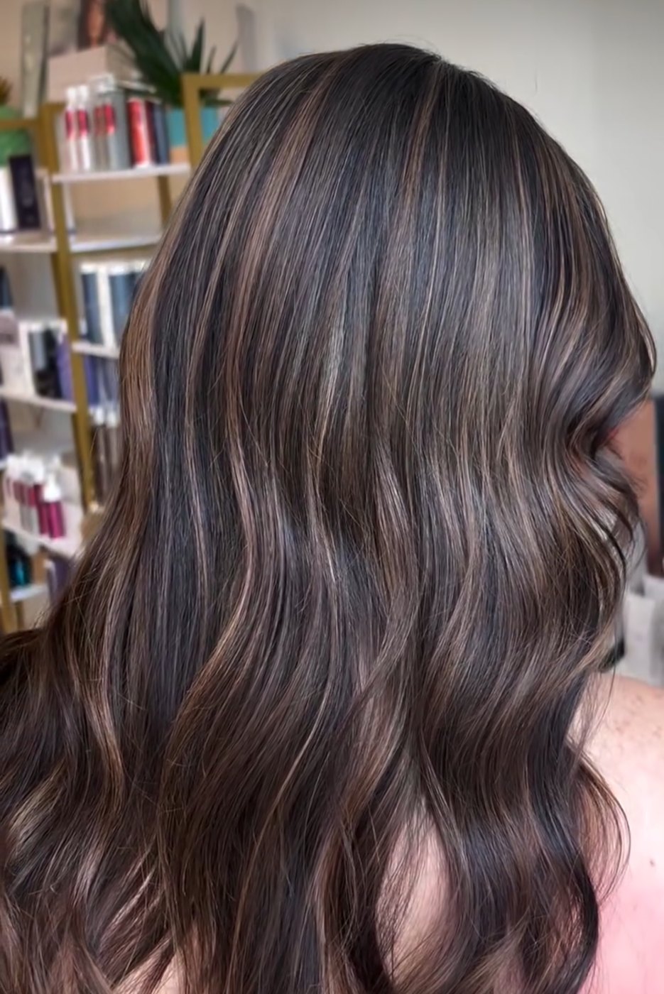 Dimensional brunette balayage by the Canterbury Color Team — soft, hand-painted brightness through dark hair.