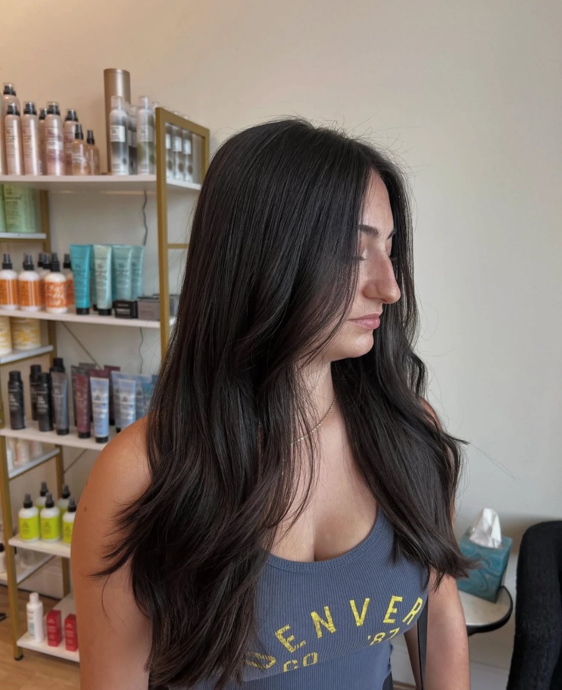 Espresso-brown glossed hair with long flowing layers and a soft bend through the ends
