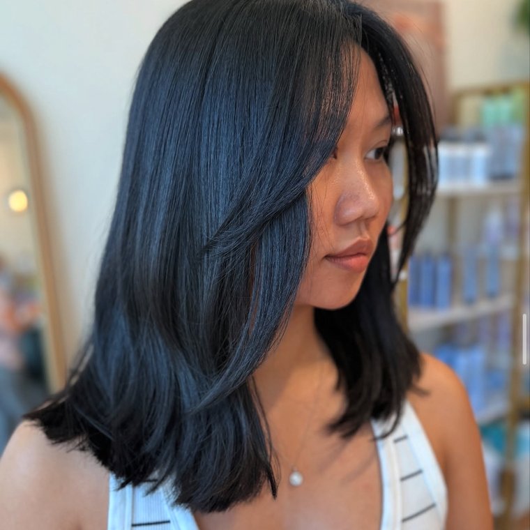 Glossy black precision-cut lob with soft face-framing layers