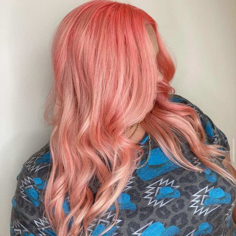 Rose-pink fashion color melting from deeper pink roots into soft peachy-pink waves