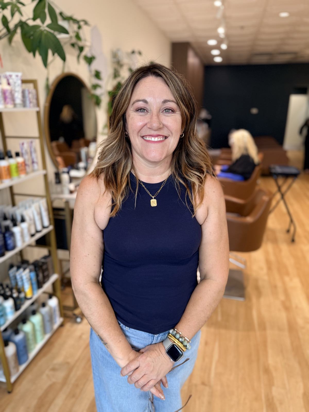 Nicole Spaude, Director Stylist at Canterbury & Co. Salon, smiling in the salon.
