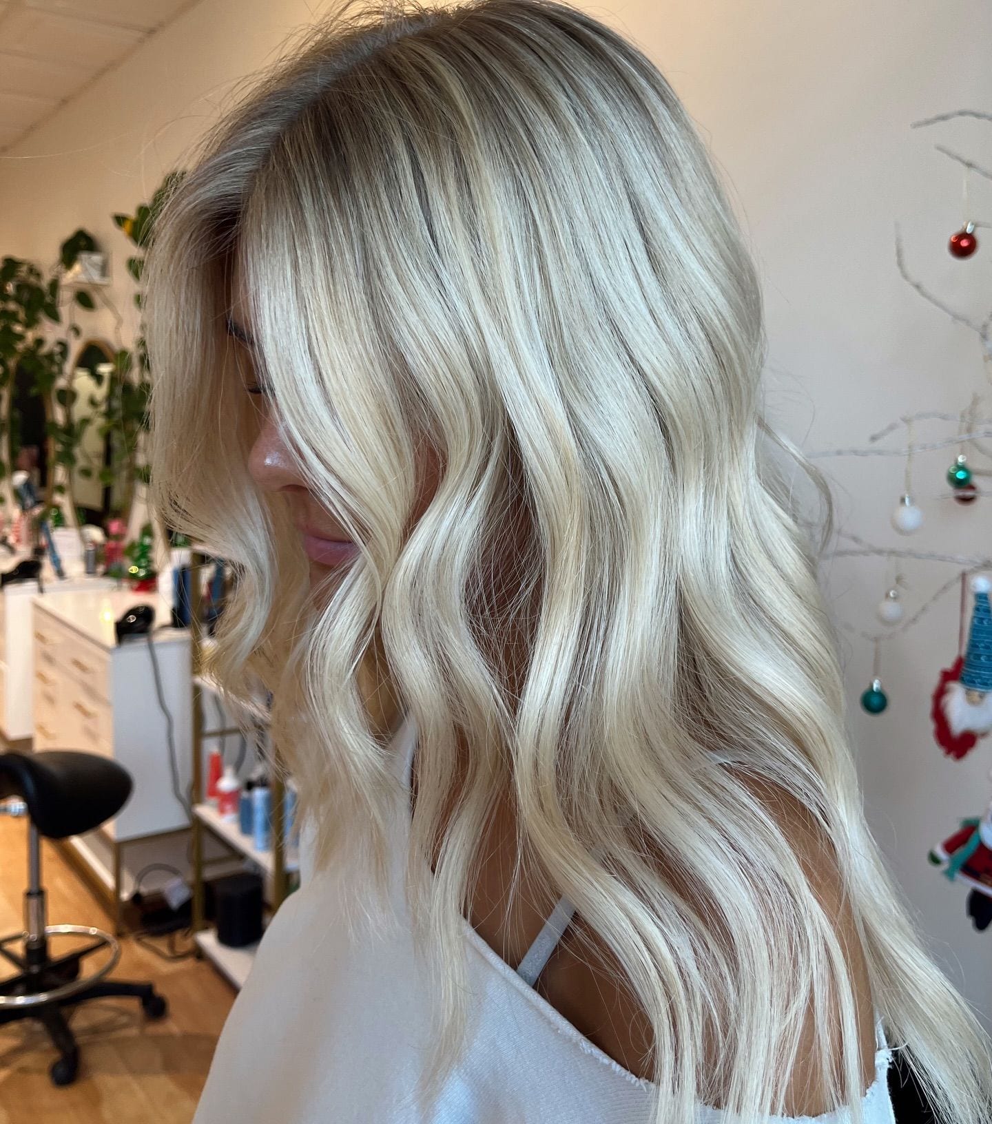 Bright blonde with a softly shadowed root in loose waves, seen from the side at Canterbury & Co. in Fort Myers