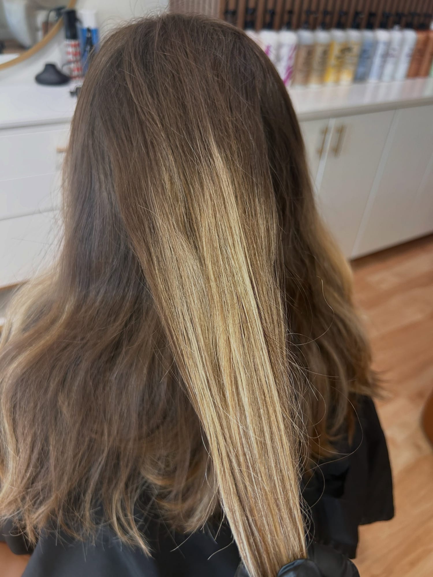 Before balayage: brown hair with a hard line between old lightened color and the darker grow-out