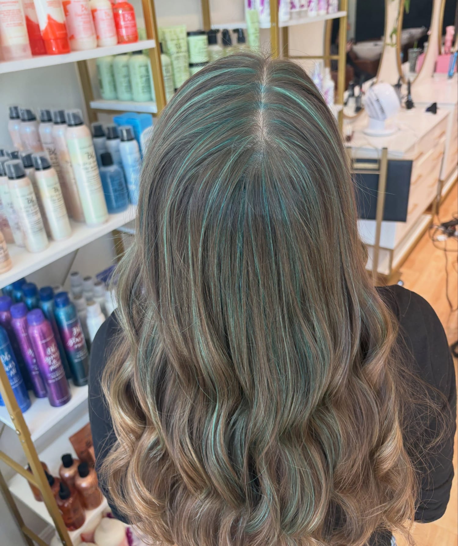 Long brunette waves with fine, subtle teal highlights through the top, seen from behind at Canterbury & Co. in Fort Myers